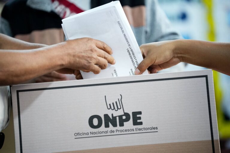 Personas votando en una mesa electoral durante las elecciones en Perú
